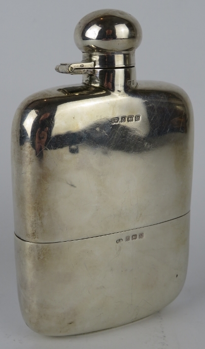 A 1920s silver hip flask with removable silver cup. Hallmarked for Birmingham 1920, maker Hubert