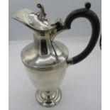 A silver pedestal ewer with ebonised handle, Sheffield 1902. Approx weight 16.5 troy oz/513 grams.