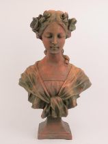 A large terracotta bust of a maiden after Gustave Van Vaerenbergh (1873 - 1927). Signed G. V.