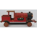 Toys: A vintage Lines Bros Ltd LMS Model Train. Painted wood with tin wheels and fittings. 55.5 cm