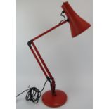 A vintage red anglepoise lamp, late 20th century. Base: 18 cm diameter. Condition report: Some age