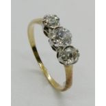 A three stone diamond ring, the graduated three old cut diamonds, claw and part rub-over set, in
