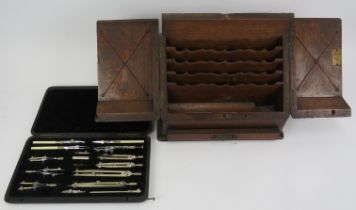 A cased set of Irish drawing instruments by Lee Guinness and a letter rack. (2 items) Rack: 27 cm