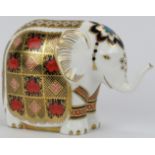 A Royal Crown Derby porcelain elephant paperweight figurine. Stopper and factory marks beneath. 10.3