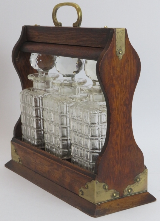 A brass mounted oak tantalus with three glass decanters, late 19th/early 20th century. 34.8 cm - Image 3 of 3