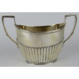 A Victorian half fluted silver sugar bowl hallmarked for London 1888, maker Army & Navy