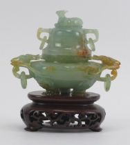 A Chinese carved jadeite tripod censer and cover, 20th century. Decorated with deer head ring