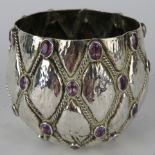 An attractive white metal pot with applied amethyst stones set into a latticework decoration. Marked