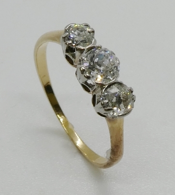 A three stone diamond ring, the graduated three old cut diamonds, claw and part rub-over set, in - Image 2 of 3