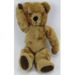 A vintage golden plush teddy bear. Partially straw stuffed. 48 cm approximate height. Condition