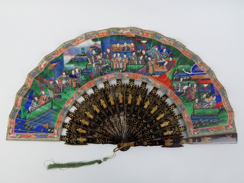 A Chinese Canton lacquered and painted folding fan, 19th century. Decorated to both sides, the black