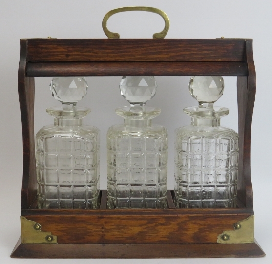 A brass mounted oak tantalus with three glass decanters, late 19th/early 20th century. 34.8 cm - Image 2 of 3