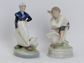 Two Royal Copenhagen porcelain figurines. Comprising a young woman and goose, numbered 528 and boy