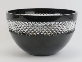 A Waterford lead crystal black glass bowl with clear diamond cut rim by John Rocha. Maker/designer