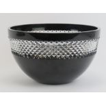 A Waterford lead crystal black glass bowl with clear diamond cut rim by John Rocha. Maker/designer