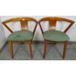 A pair of mid-century beech tub chairs by Greaves & Thomas, the seats covered in emerald green