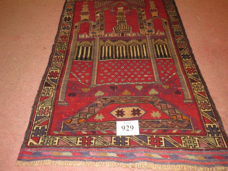 A Persian Beluchi rug. Temple scene on red ground. 137cm x 90cm (approx). Condition report: Good