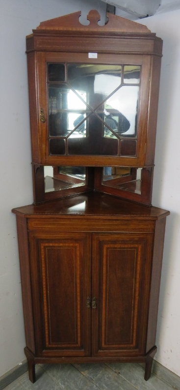 An Edwardian mahogany tall corner cupboard, crossbanded and parquetry strung, the top section with