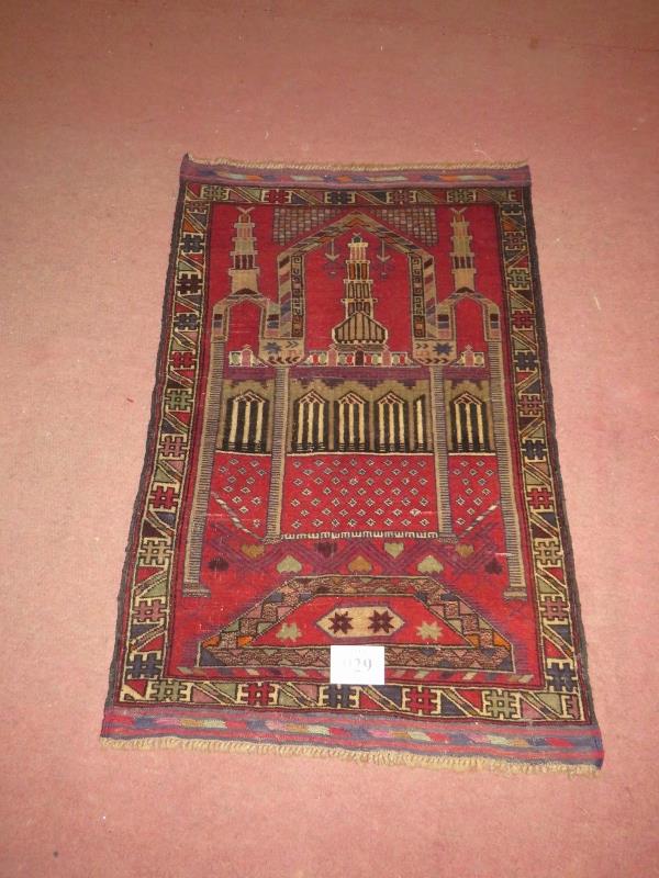 A Persian Beluchi rug. Temple scene on red ground. 137cm x 90cm (approx). Condition report: Good - Image 2 of 2