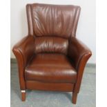 A contemporary armchair, upholstered in tobacco brown leather, on sabre legs. H98cm W72cm D76cm (