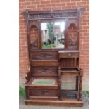 A 19th century Gothic Revival oak hallstand with relief carved acanthus decoration, having an