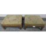 A pair of Regency Period giltwood footstools, retaining the original upholstery, on fluted