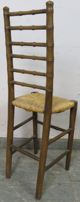 A 19th century faux bamboo ladderback child’s correctional chair, having a rush seat, on tapered - Image 3 of 3