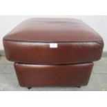 A contemporary square footstool upholstered in brown leather, on tapering block feet. H46cm W60cm