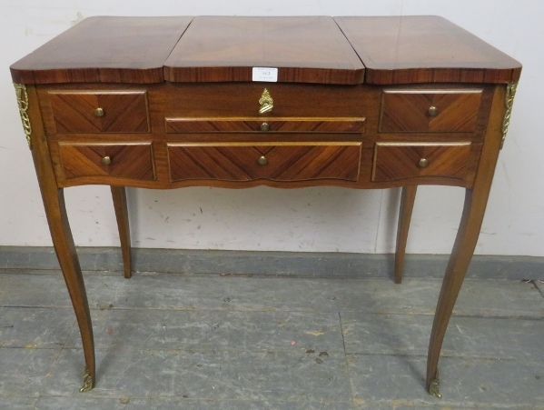 A vintage French mahogany and tulipwood dressing table with gilt brass mounts, the rising central