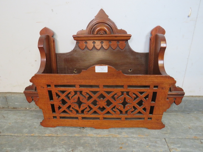 An unusual Aesthetic Movement mahogany wall-mounting magazine/letter rack with carved and pierced