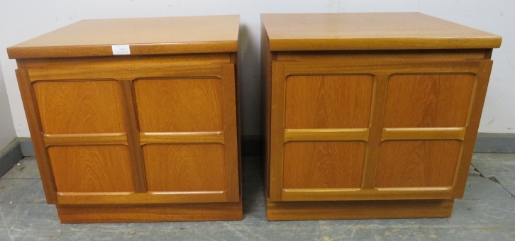 A pair of mid-century teak bedside cabinets by Parker Knoll, the doors with lattice mouldings