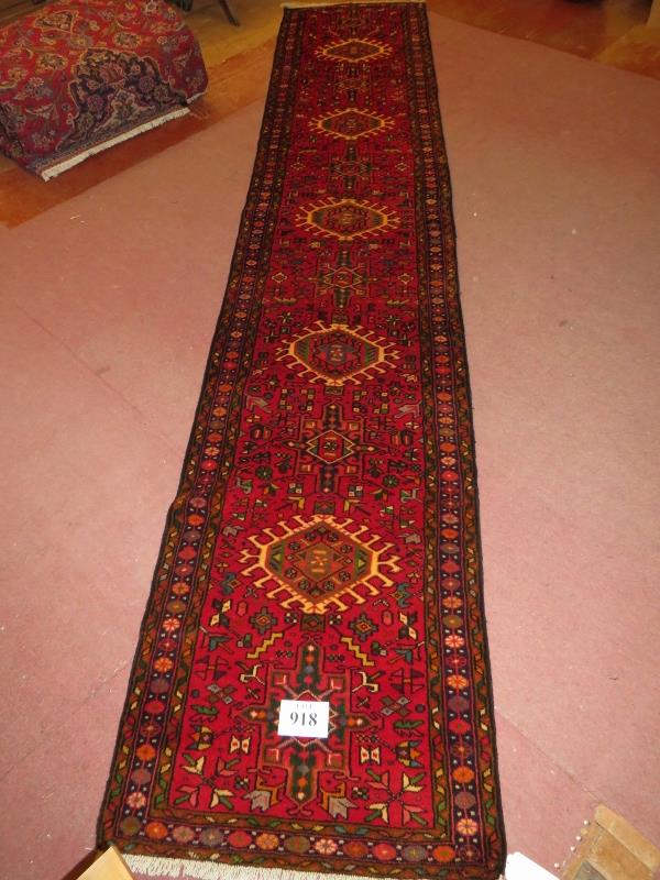 North West Persian Heriz runner, central repeat pattern on a red ground. 395cm x 78cm (approx). - Image 2 of 3