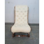 A 19th century walnut slipper chair, upholstered in buttoned calico material, on scrolled supports