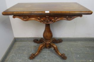 A good early Victorian rosewood turnover tea table, having acanthus carved and scrolled frieze in