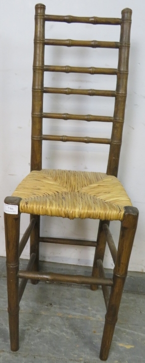 A 19th century faux bamboo ladderback child’s correctional chair, having a rush seat, on tapered