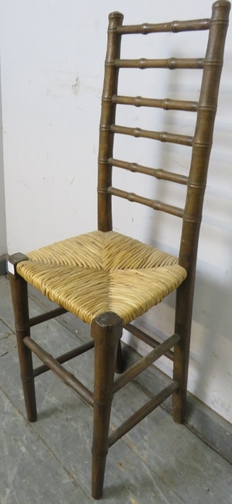 A 19th century faux bamboo ladderback child’s correctional chair, having a rush seat, on tapered - Image 2 of 3