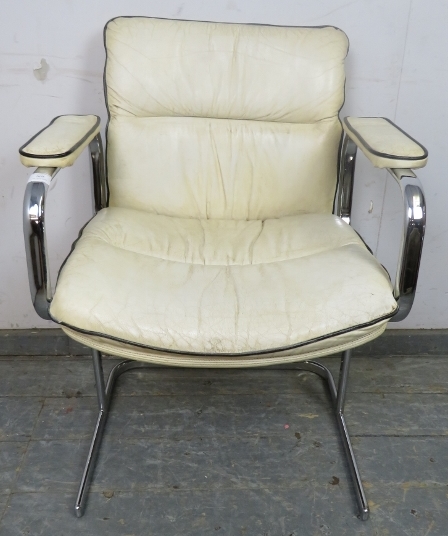 A mid-century desk chair in the manner of Peiff, upholstered in cream leather with black piping,