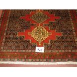 North West Persian Senneh rug, three central locking motifs surrounded by repeat pattern, salmon