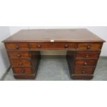 A 19th century mahogany pedestal desk, housing a configuration of nine graduated oak-lined drawers