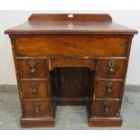 An 18th century and later walnut and oak ladies’ kneehole desk, housing central blind drawer above a