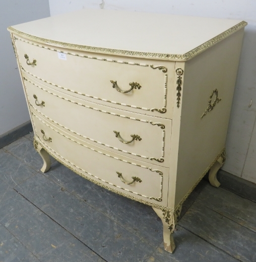 A vintage French bow-fronted chest in the Louis XV taste, painted cream and gold, housing three long - Image 2 of 3