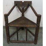 A vintage African hardwood tribal chieftain’s chair, having a carved back rest joined with bobbin