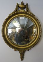 A vintage convex wall mirror in the Regency taste, within an ornate gilt surround, the cornice in