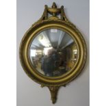 A vintage convex wall mirror in the Regency taste, within an ornate gilt surround, the cornice in