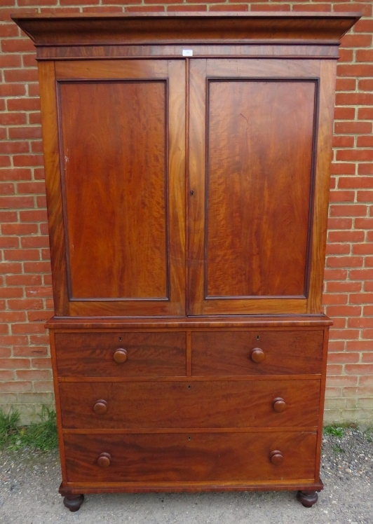 A Victorian mahogany linen press of good colour, the moulded cornice above panelled doors opening