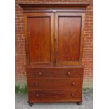 A Victorian mahogany linen press of good colour, the moulded cornice above panelled doors opening