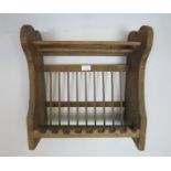 A small antique pine plate rack with shaped end supports. Can be either wall-mounted or