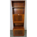 A mid-century tall narrow tropical hardwood bookcase by Omman Jun, having two open shelves above