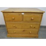 A small vintage pine chest, housing two short over two long drawers with turned wooden handles, on a