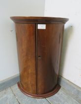 A George III flame mahogany bow-fronted hanging corner cupboard of diminutive proportions, having